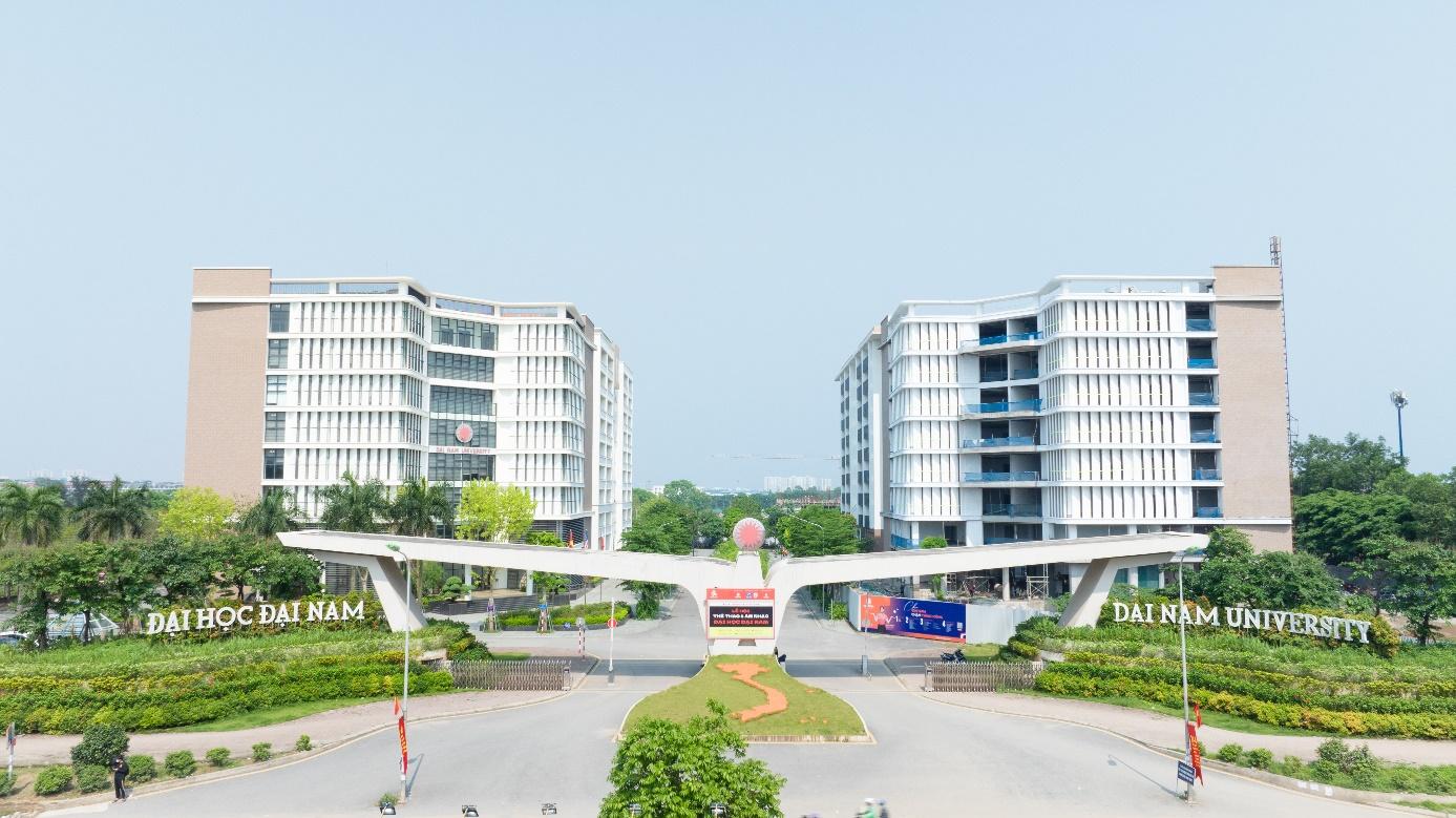 A bridge over a road with buildings in the background  Description automatically generated