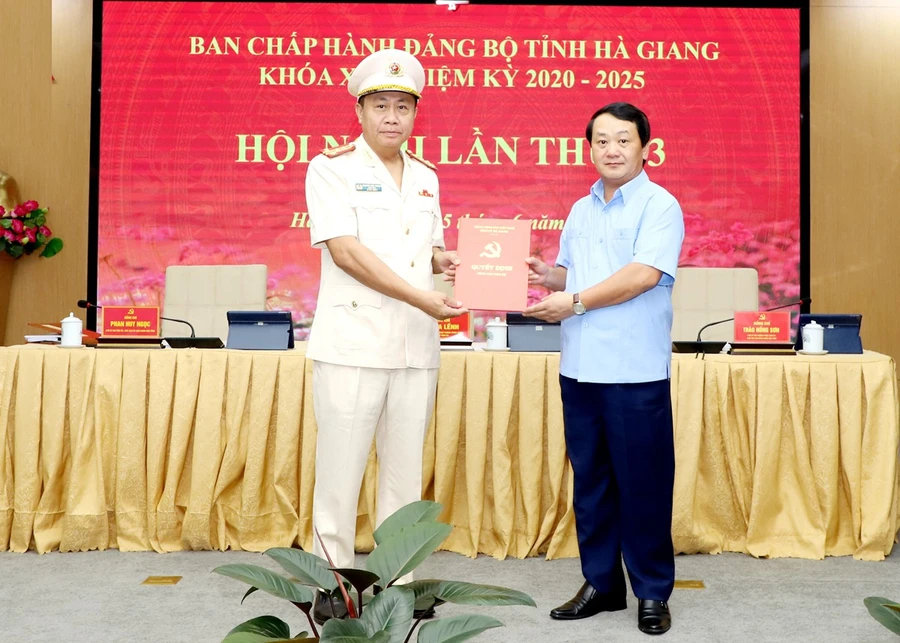 Bí thư Tỉnh ủy Hà Giang Hầu A Lềnh (bìa phải) trao quyết định của Ban Bí thư cho Đại tá Nguyễn Đức Thuận.